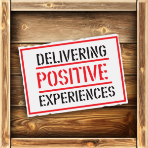 RJ Logistics Delivering Positive Experiences sign on a wood box